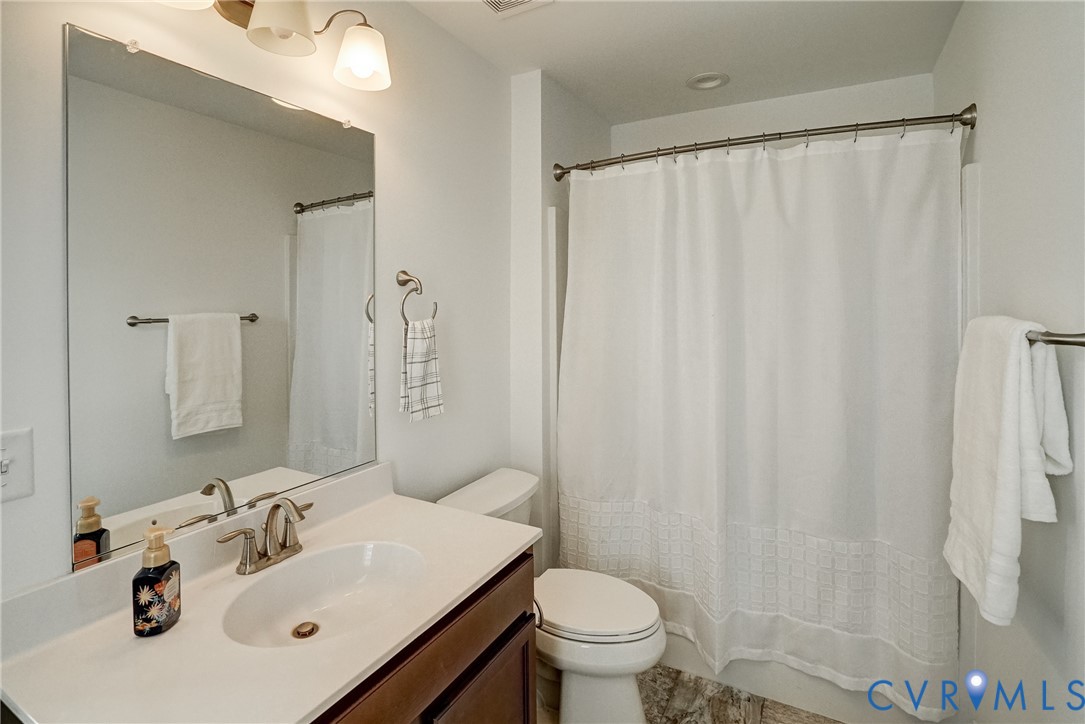 119 Thorncliff Road Ashland, VA 23005 - Photo 20 of 30 a bathroom with a sink a toilet and shower curtain