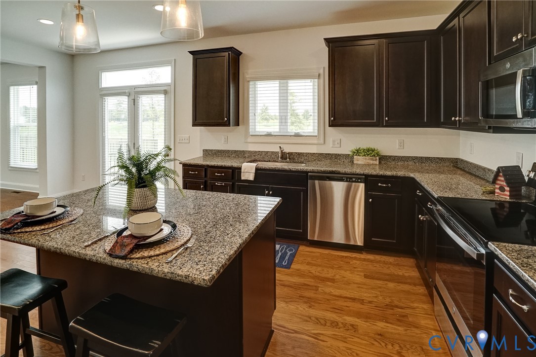 119 Thorncliff Road Ashland, VA 23005 - Photo 3 of 30 a kitchen with a sink and wooden cabinets