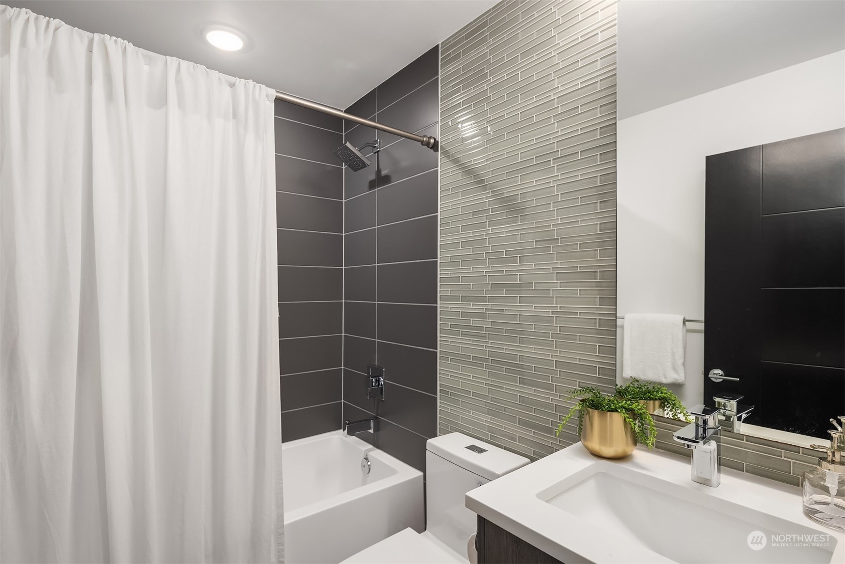 2307 West Raye Street Seattle, WA 98199 - Photo 15 of 38 a bathroom with a sink and bathtub