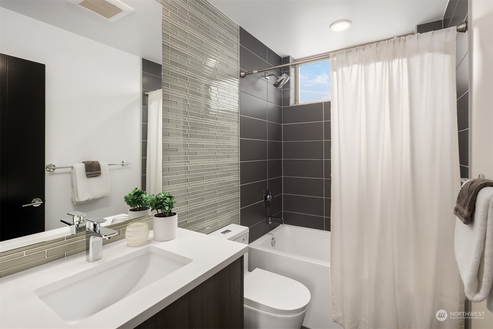 2307 West Raye Street Seattle, WA 98199 - Photo 17 of 38 a bathroom with a sink toilet and shower