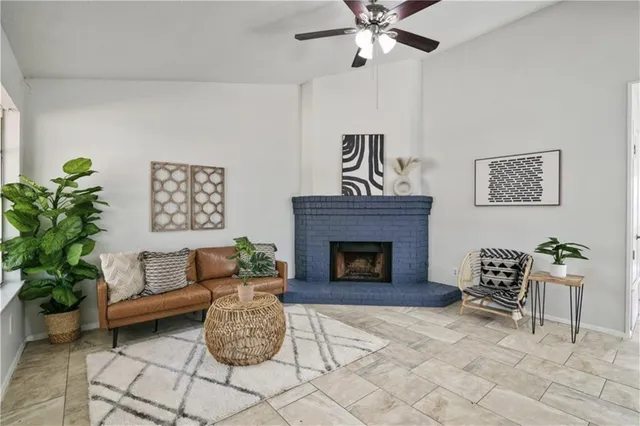 a living room with furniture and a fireplace