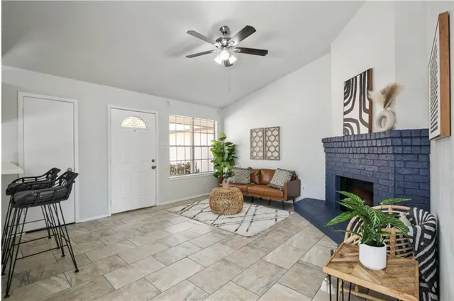 a living room with furniture and a fireplace
