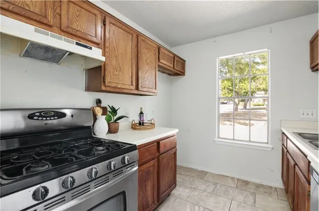 a kitchen with a stove and a sink