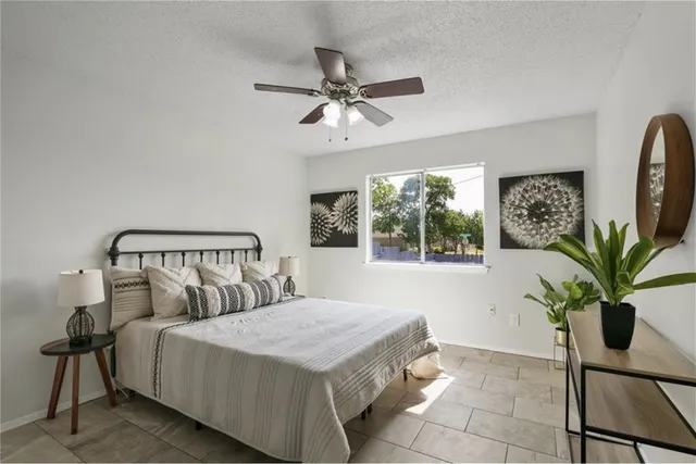 a bedroom with a bed and a potted plant