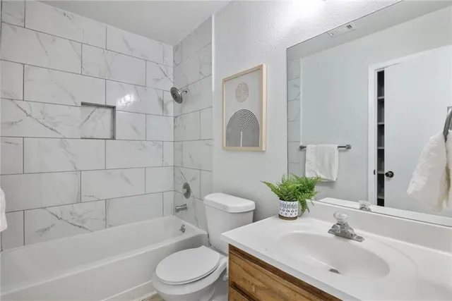 a bathroom with a sink a toilet and bathtub