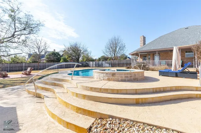 a view of a swimming pool with outdoor seating
