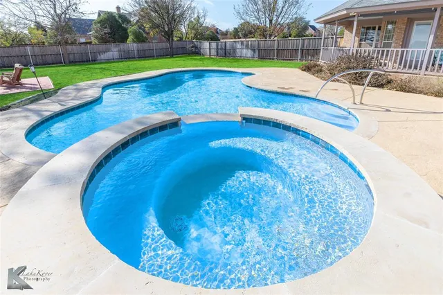 a view of a swimming pool with a yard
