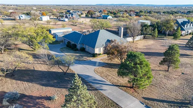 an aerial view of a house with a yard pool and outdoor seating