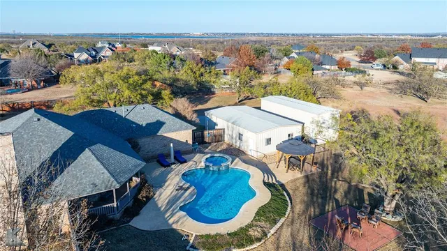 an aerial view of a house swimming pool and ocean view