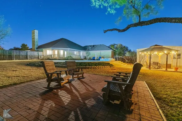 a view of a patio with a table chairs and wooden floor