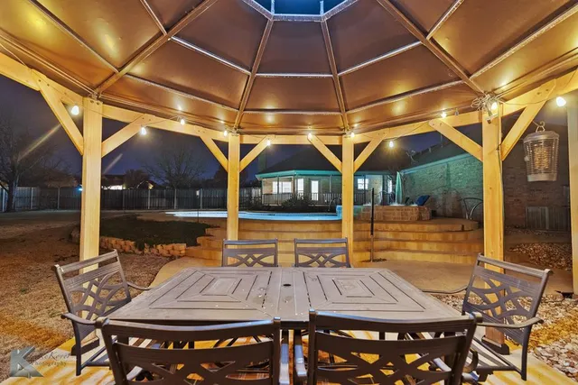 a view of a patio with table and chairs with wooden floor