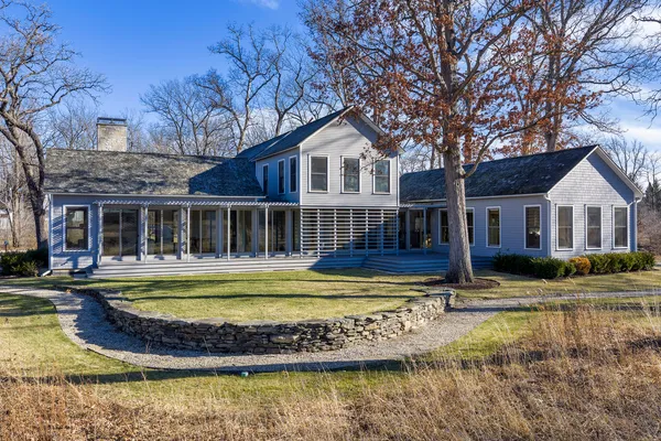 a view of house with swimming pool next to a yard