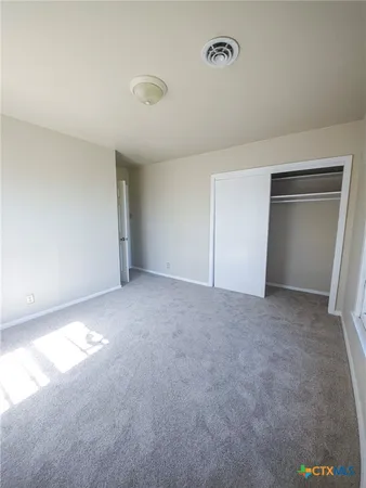 a view of an empty room and closet area