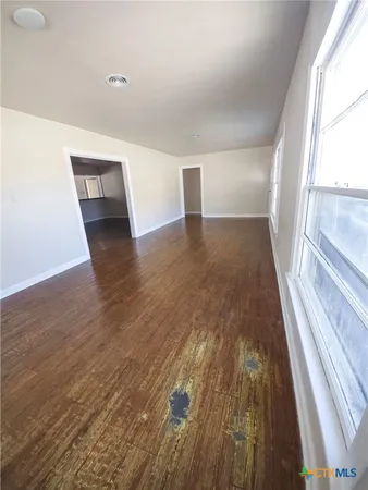 a view of a hallway view with wooden floor and staircase