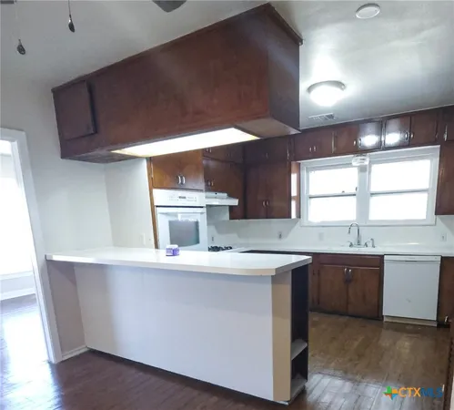 a kitchen with stainless steel appliances a sink and a stove