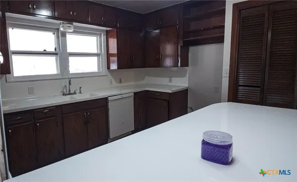 a kitchen with a sink and a window