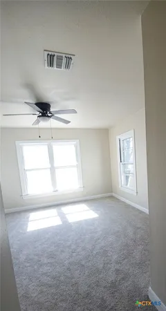 an empty room with windows and closet