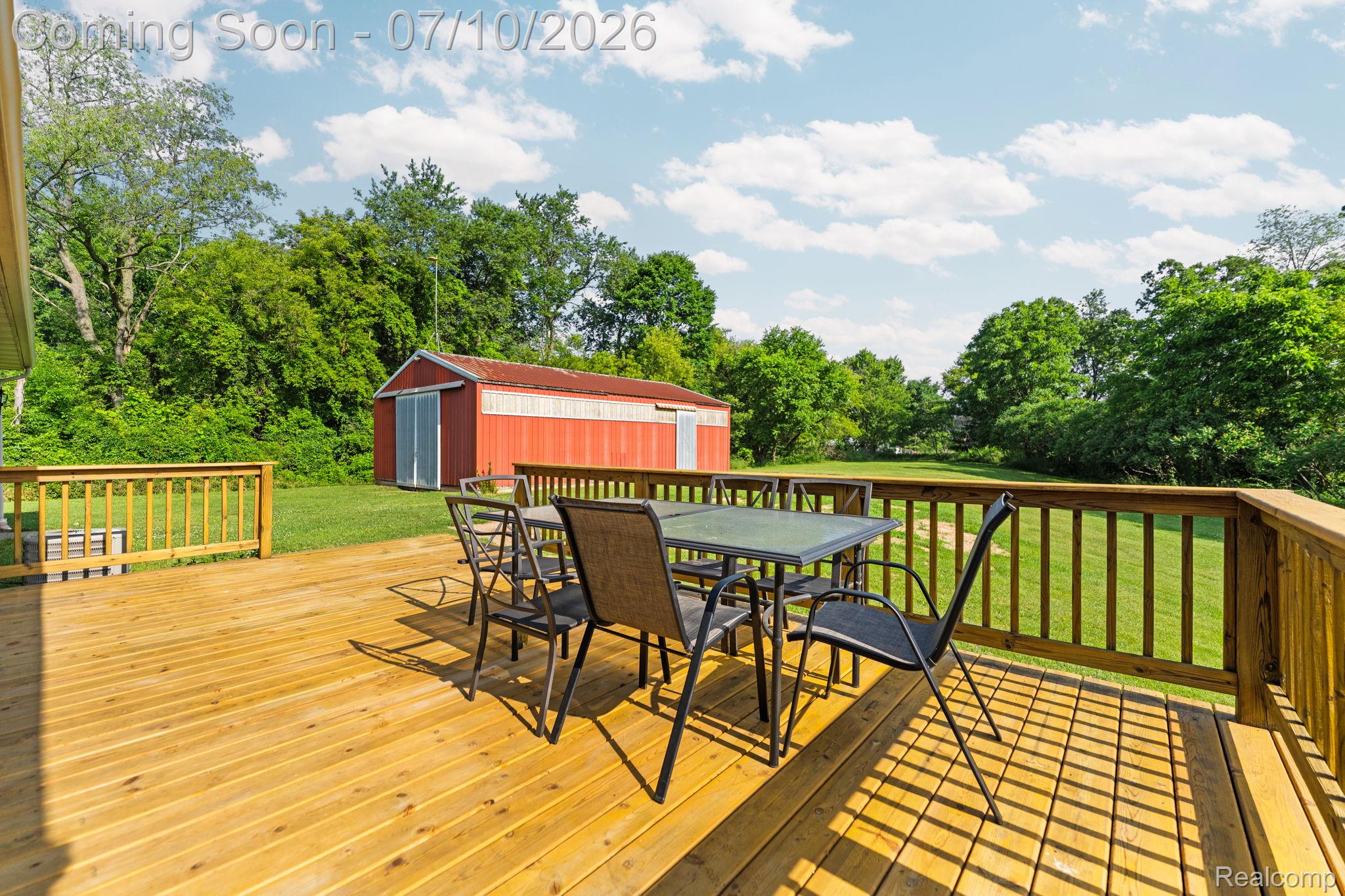 3144 North Nicholson Road Fowlerville, MI 48836 - Photo 30 of 70 Expansive wood deck with a natural finish, featuring a full wood railing