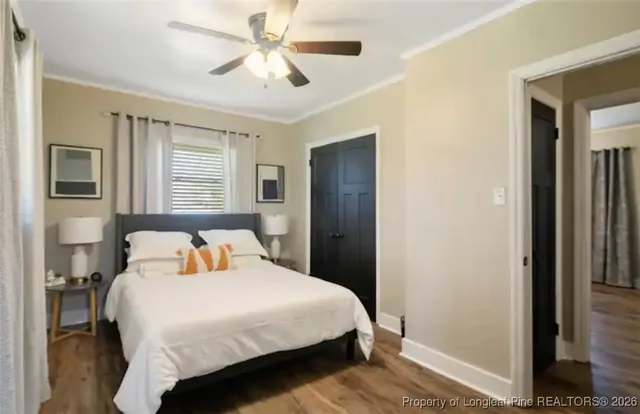 a bedroom with a large bed and a chandelier