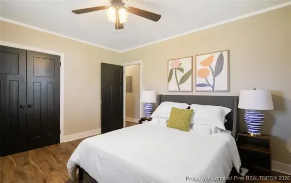 a bedroom with a bed and lamps