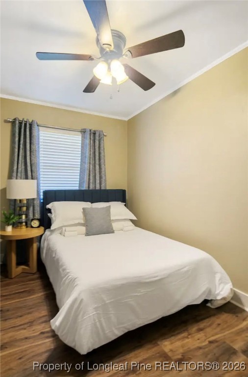 4611 Campground Road Fayetteville, NC 28314 - Photo 16 of 17 a bedroom with a bed and a chandelier