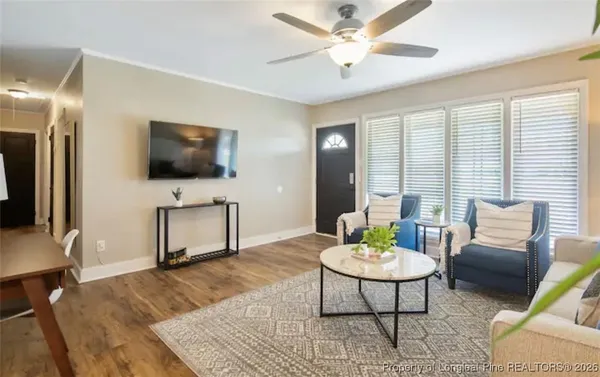 a living room with furniture and a flat screen tv
