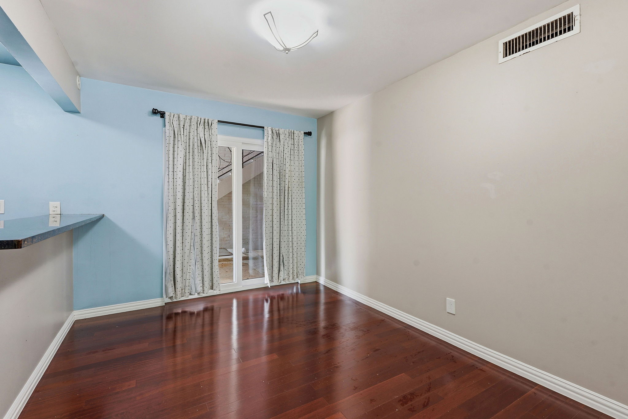 1210 Windsor Road, Unit 104 Austin, TX 78703 - Photo 12 of 27 Interior space featuring rich wood-finish flooring, light blue and neutral wall colors, a white ceiling, recessed lighting, and a double-door entryway