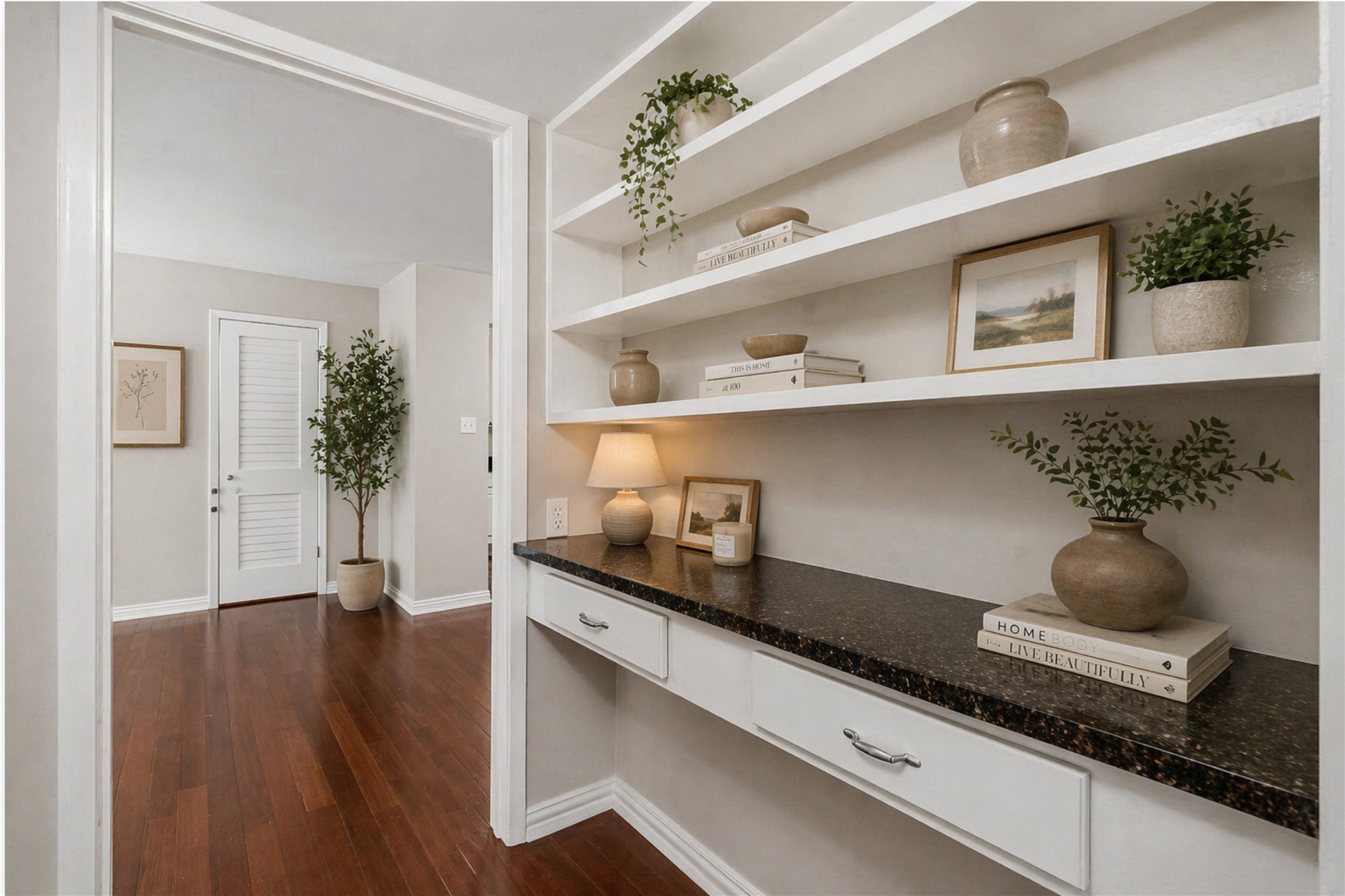 1210 Windsor Road, Unit 104 Austin, TX 78703 - Photo 13 of 27 Built-in shelving unit with a dark speckled countertop, integrated drawers, and rich wood-finish flooring