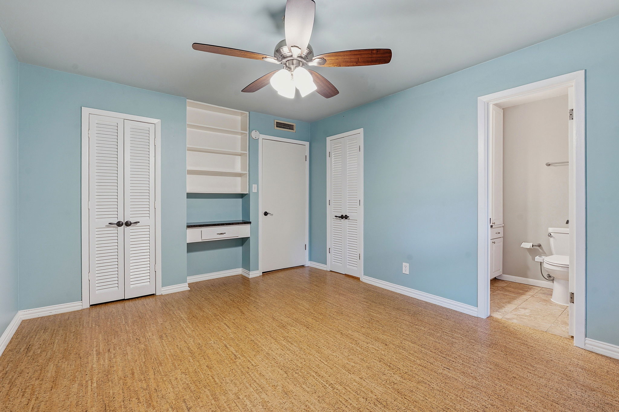 1210 Windsor Road, Unit 104 Austin, TX 78703 - Photo 16 of 27 Interior room featuring wood-finish flooring and a ceiling fan with light fixture