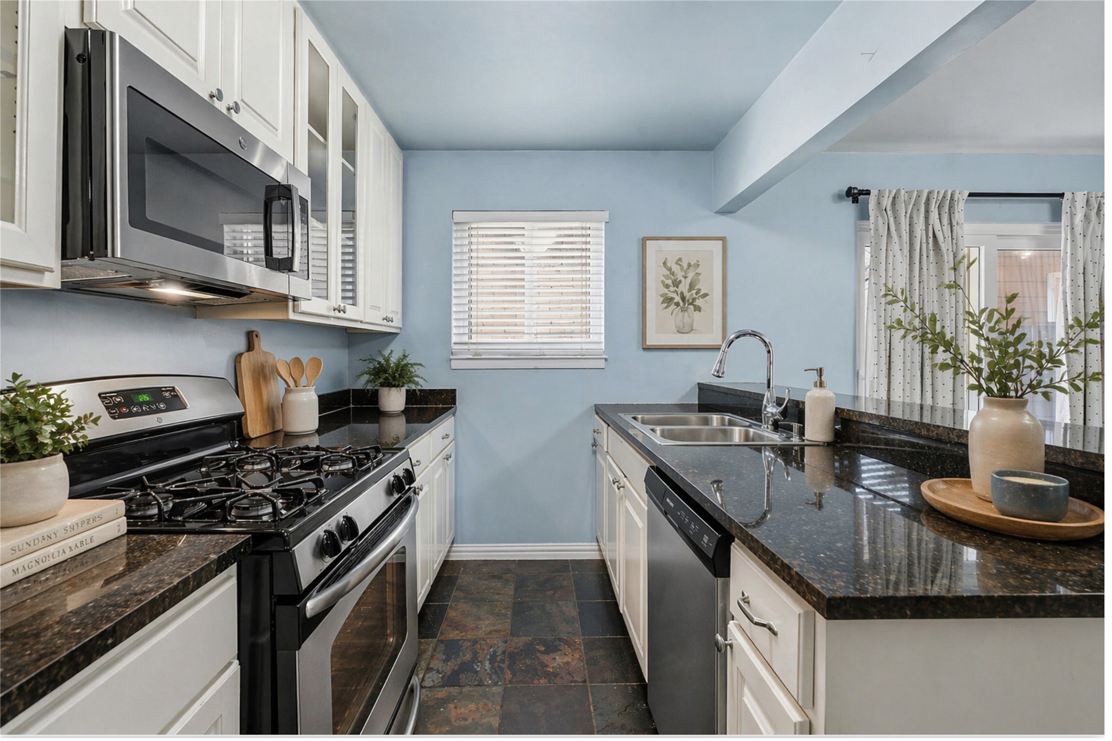 1210 Windsor Road, Unit 104 Austin, TX 78703 - Photo 4 of 27 Kitchen featuring white cabinetry, dark stone countertops, and stainless steel appliances