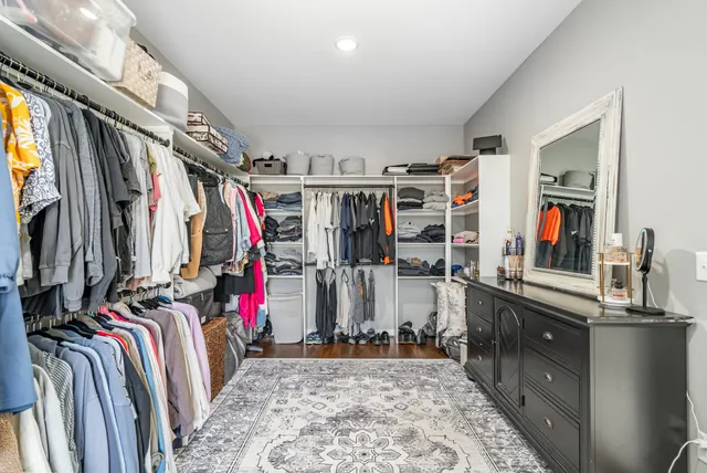 a view of walk in closet with clothes