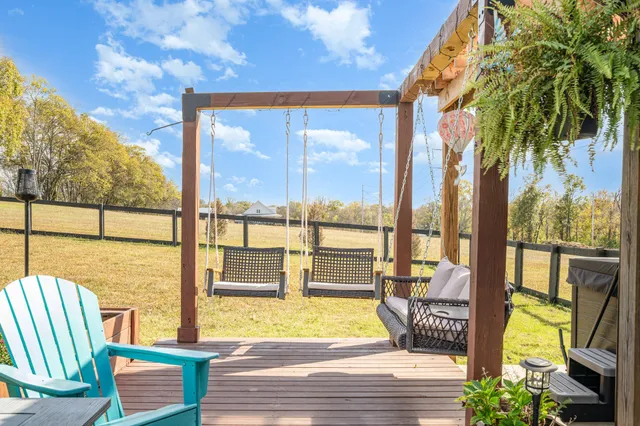 a view of a balcony with floor to ceiling windows wooden floor and outdoor space