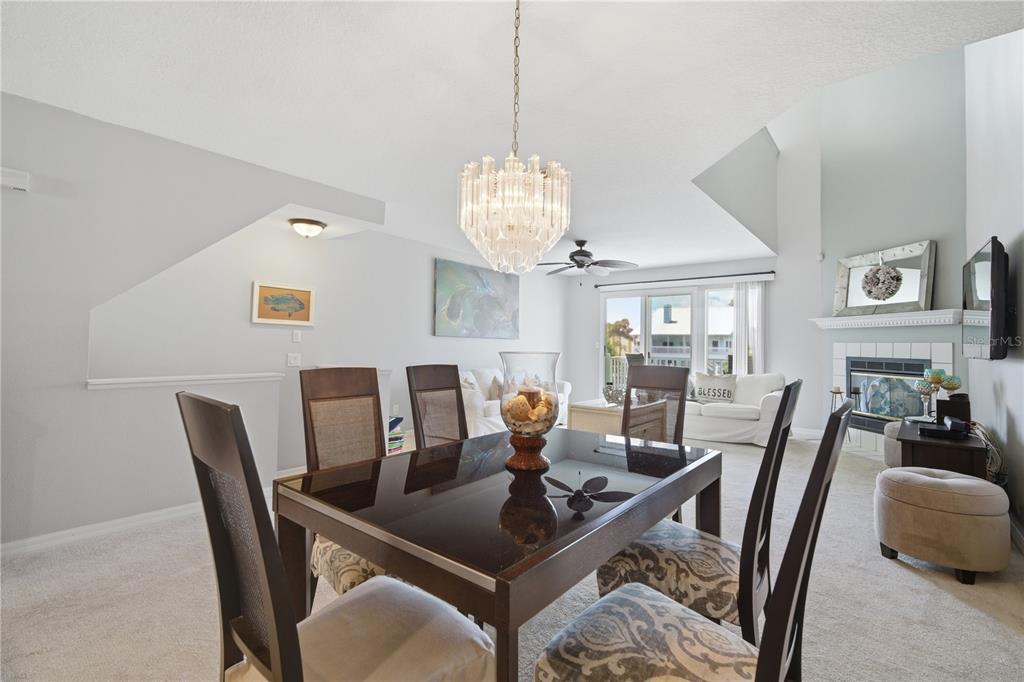 643 Garland Circle Indian Rocks Beach, FL 33785 - Photo 18 of 81 a view of a dining room with furniture a chandelier and wooden floor