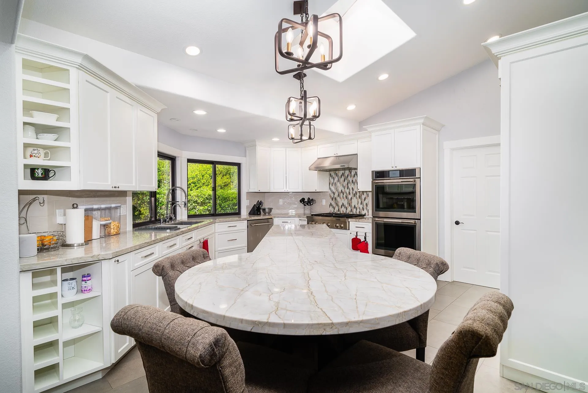 14574 Millards Road Poway, CA 92064 - Photo 16 of 75 a kitchen with stainless steel appliances kitchen island granite countertop a sink a stove a dining table and chairs