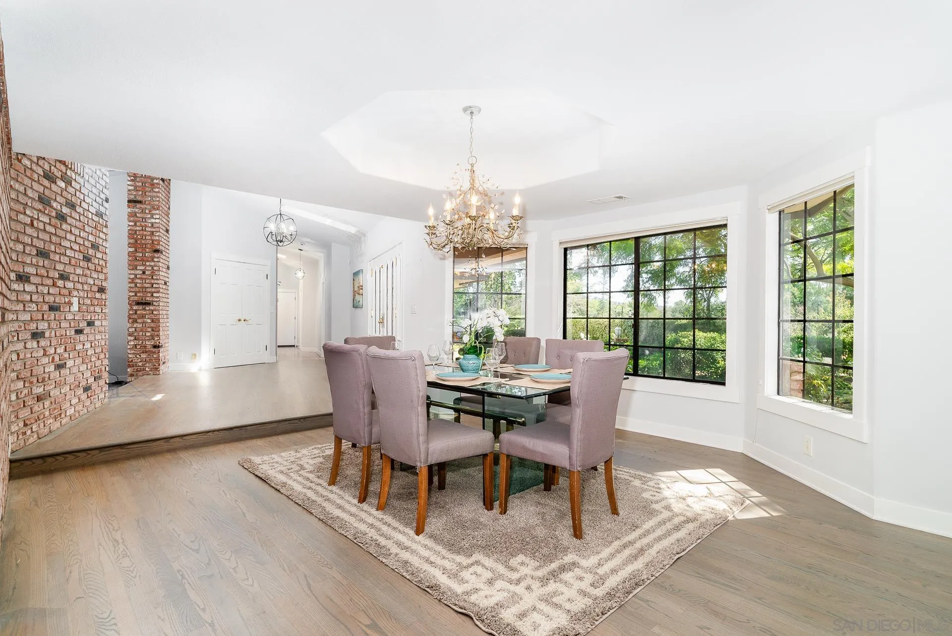 14574 Millards Road Poway, CA 92064 - Photo 19 of 75 a dining room with furniture a chandelier and wooden floor