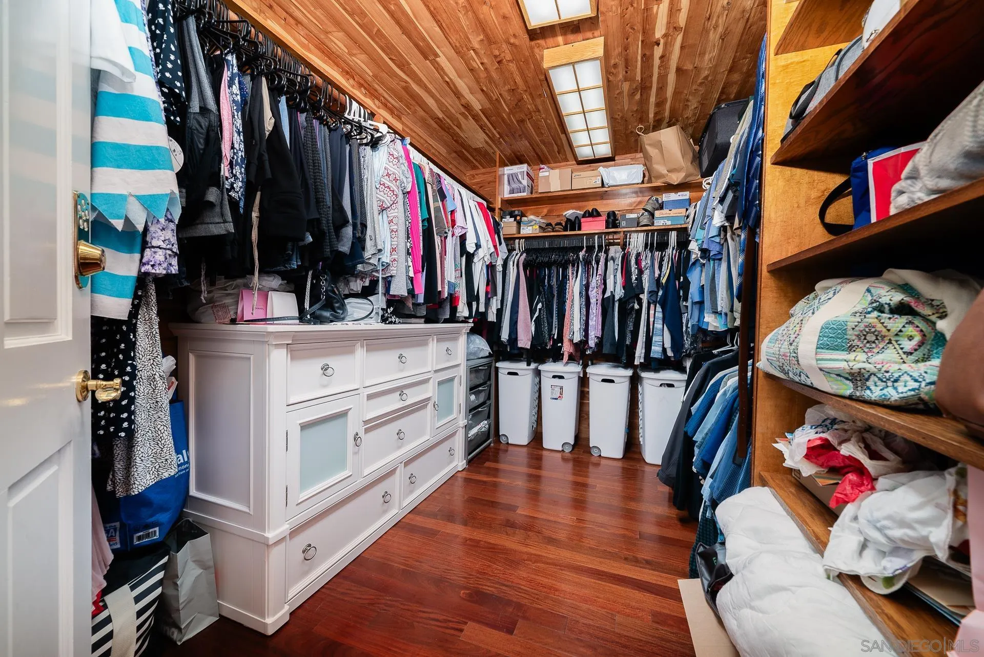 14574 Millards Road Poway, CA 92064 - Photo 33 of 75 a view of walk in closet with clothes and shoes