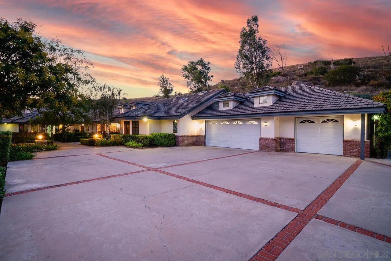 14574 Millards Road Poway, CA 92064 - Photo 4 of 75 a front view of a house with a yard and a garage