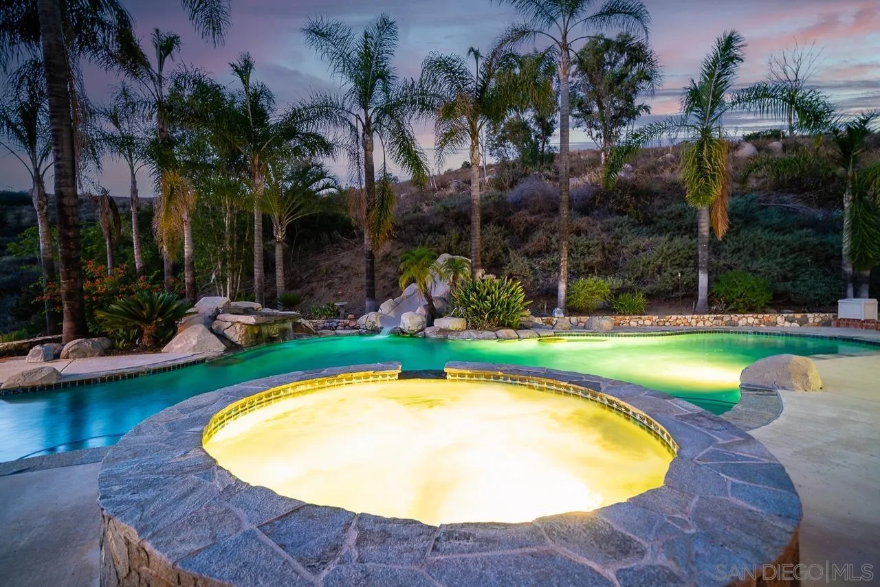 14574 Millards Road Poway, CA 92064 - Photo 42 of 75 a view of a swimming pool with a garden and palm trees