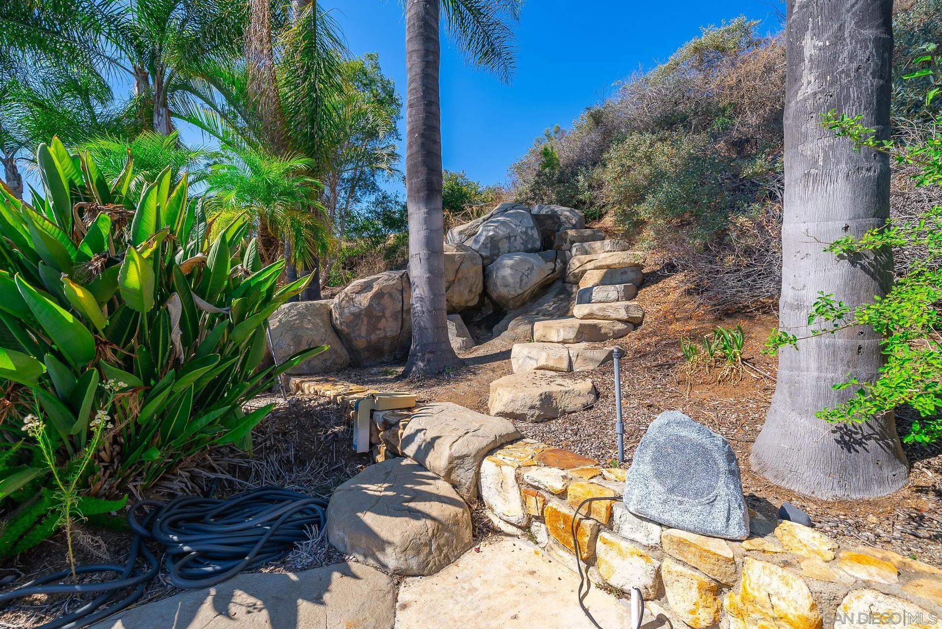 14574 Millards Road Poway, CA 92064 - Photo 70 of 75 a backyard of a house with table and chairs potted plants