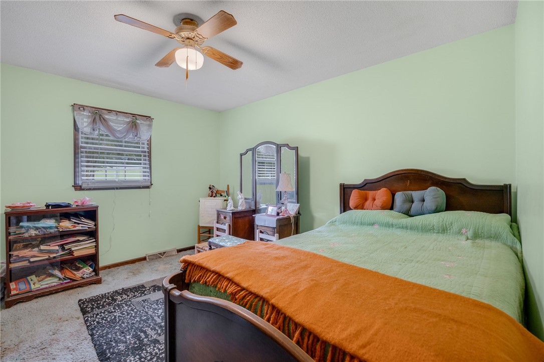 131 Bowen Road Anderson, SC 29621 - Photo 20 of 36 A classic bedroom showcases comfortable carpeted flooring and wood window frames.