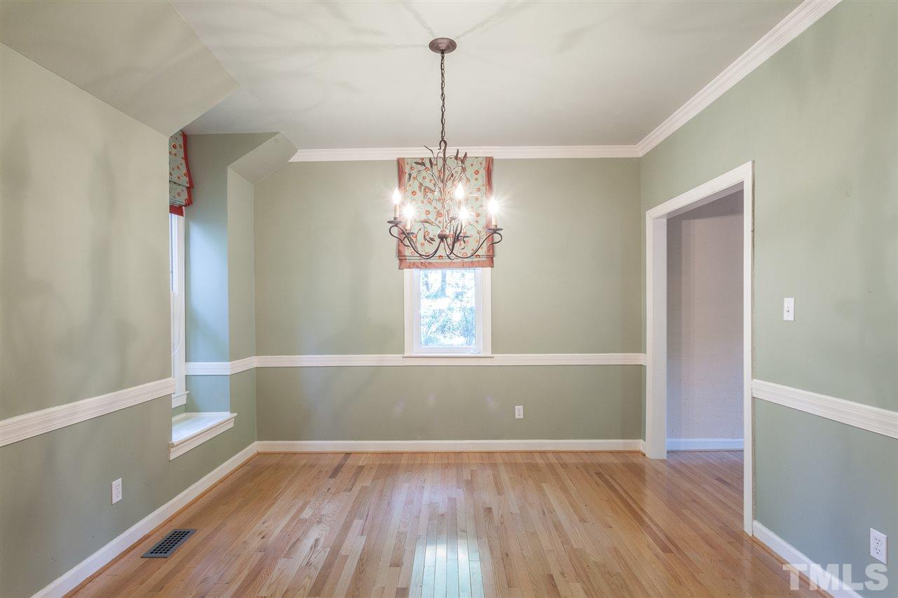 1711 Falls Church Road Raleigh, NC 27609 - Photo 3 of 29 a view of empty room with wooden floor and window