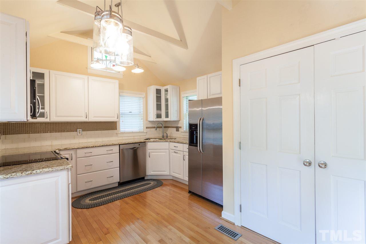 1711 Falls Church Road Raleigh, NC 27609 - Photo 8 of 29 a kitchen with a refrigerator a sink and cabinets
