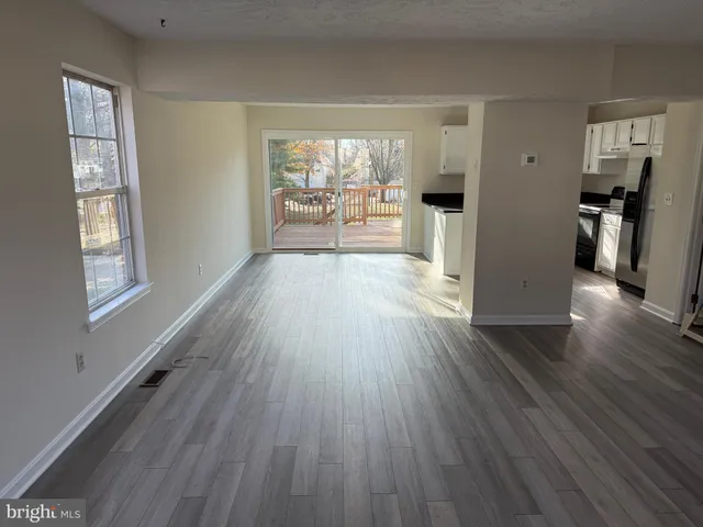 a view of an empty room and a ceiling fan