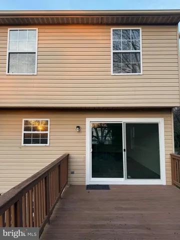 a view of house with backyard and deck