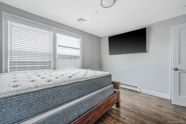 a view of a livingroom with wooden floor and windows