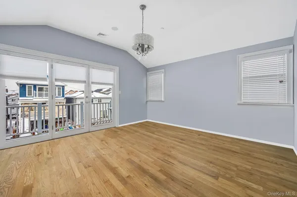 a spacious bedroom with a bed and a television