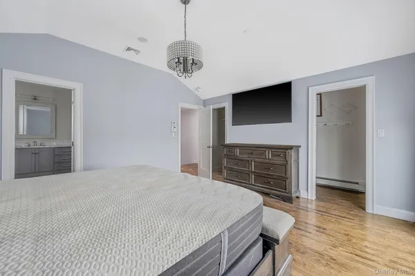 a view of a room with wooden floor and white walls