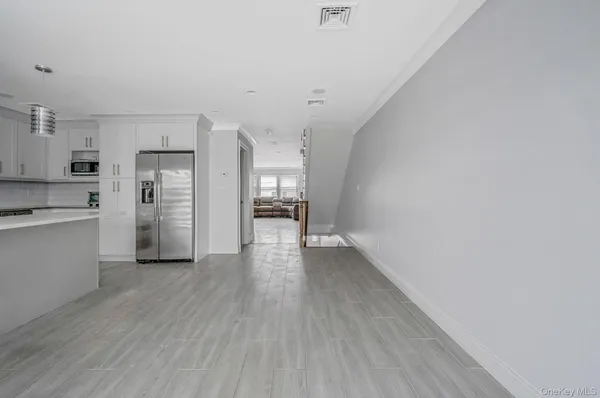 a view of kitchen view wooden floor and electronic appliances