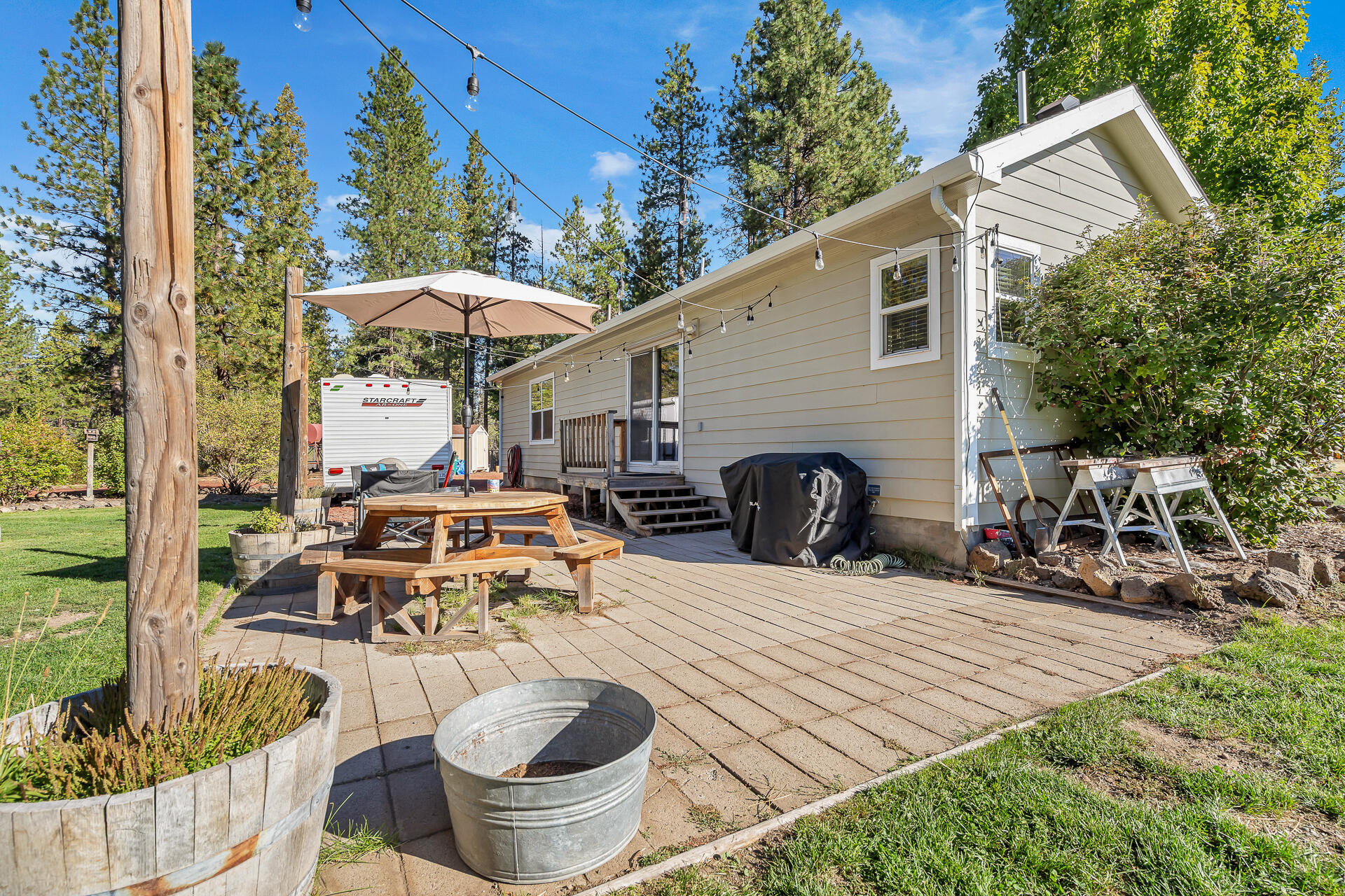 42048 Wilcox Road Hat Creek, CA 96040 - Photo 114 of 134 a view of a patio with table and chairs potted plants with wooden fence