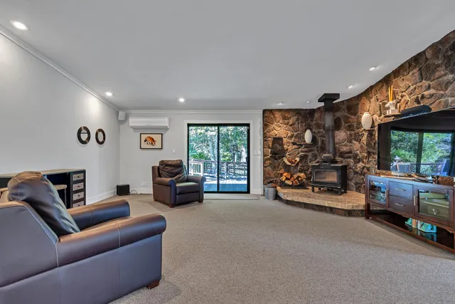 a view of an empty room with stairs and a ceiling fan